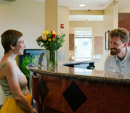 Gresham Advanced Dentistry – Front Desk Welcome Front desk team welcoming a patient at Gresham Advanced Dentistry