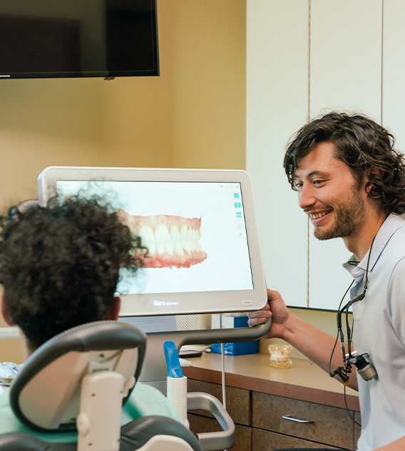Gresham Advanced Dentistry – Insurance Financing Dentist explaining treatment and insurance options to a patient at Gresham Advanced Dentistry