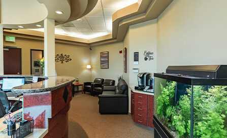Patient waiting area with aquarium at Gresham Advanced Dentistry