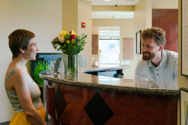 Front desk team helping a new patient at Gresham Advanced Dentistry in Gresham, OR