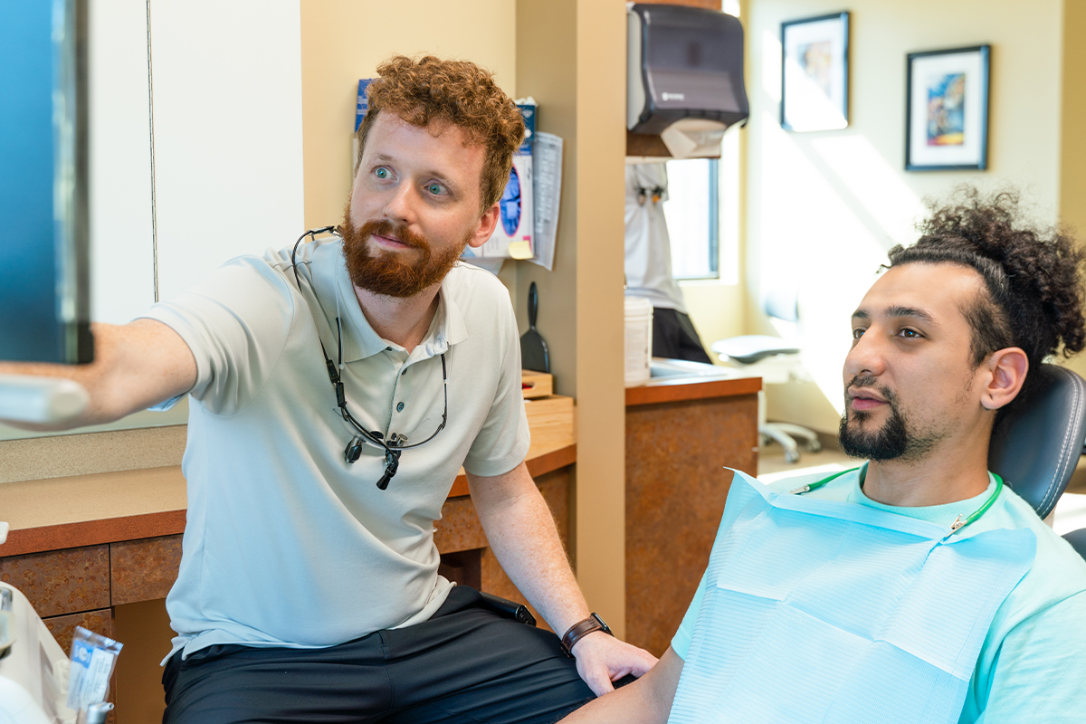 Gresham Advanced Dentistry – Office Tour 14 Dentist reviewing digital scans with a patient at Gresham Advanced Dentistry