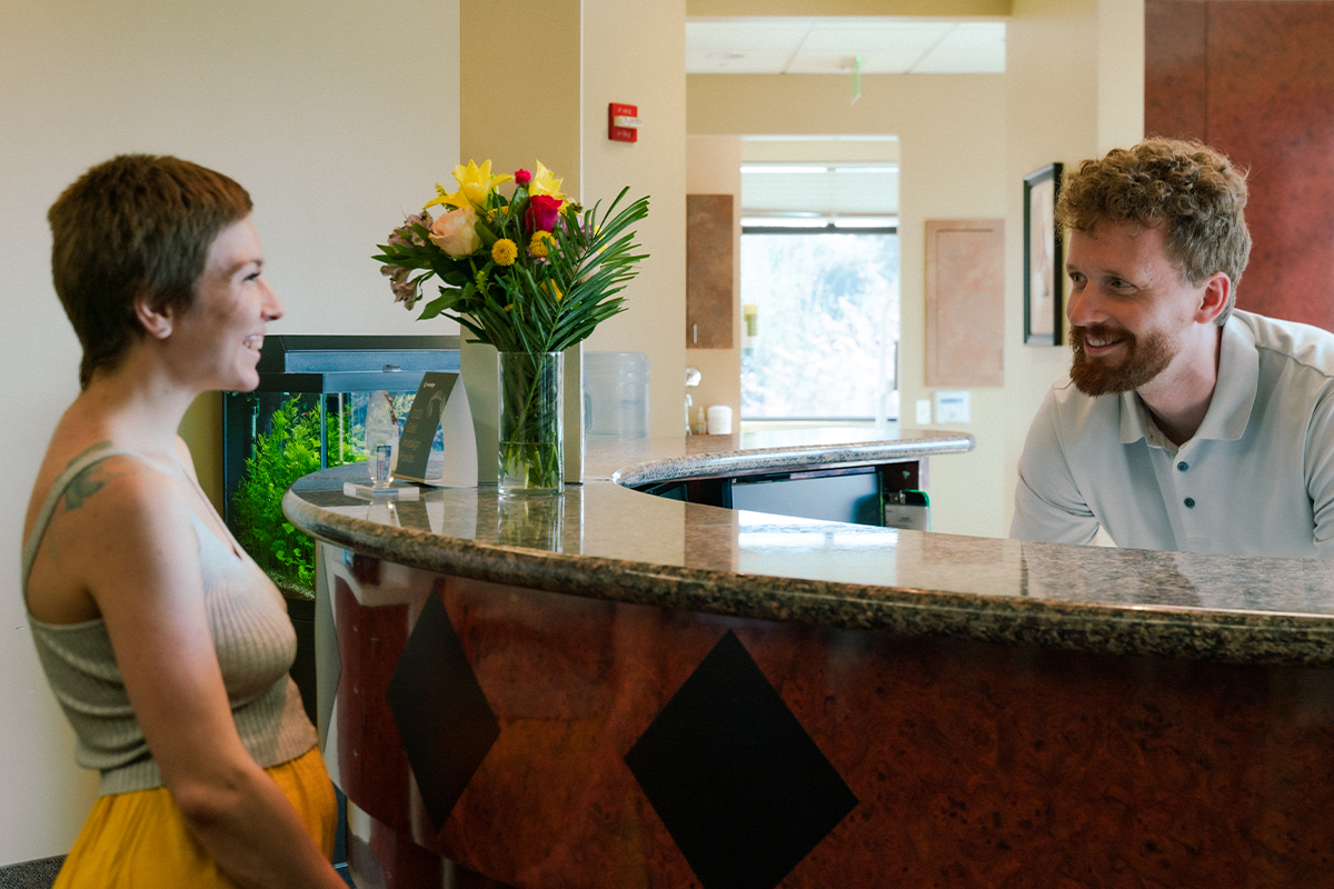 Gresham Advanced Dentistry – Office Tour 6 Front desk team welcoming a patient at Gresham Advanced Dentistry in Gresham, OR